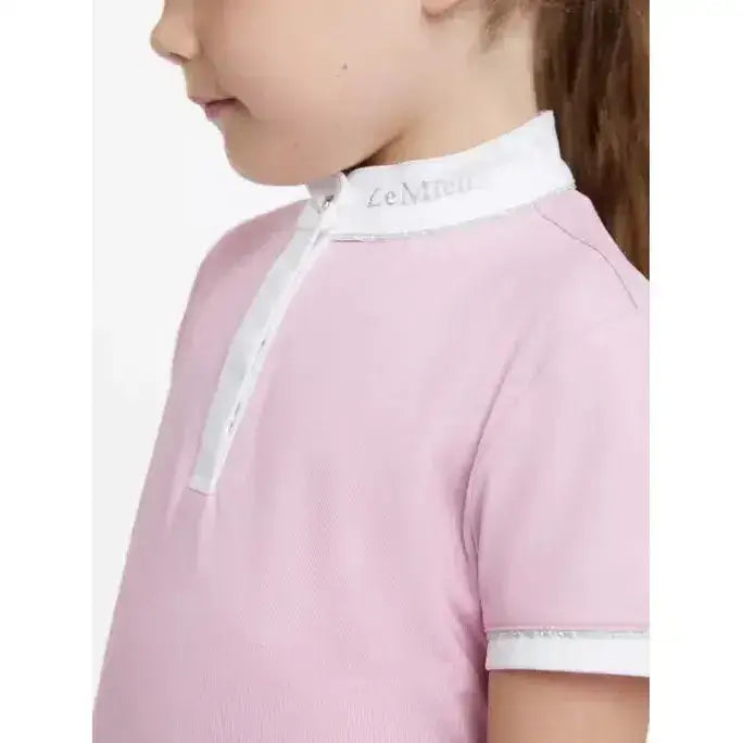 Pink lemieux mini bella children’s polo shirt with white collar and sleeve trim in subtle textured weave