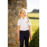 White lemieux mini bella short-sleeved polo shirt with subtle gray horse print perfect competition wear