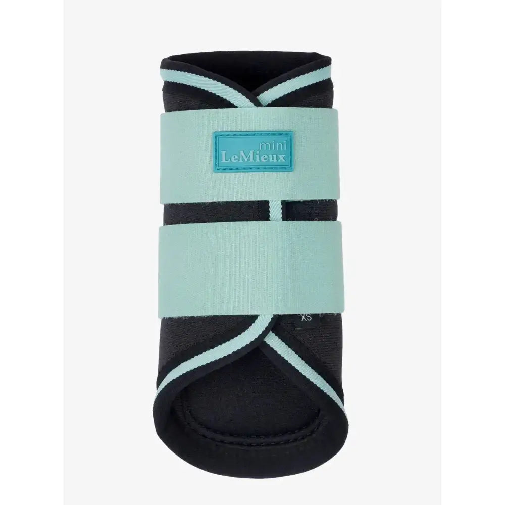 A sleek black and mint green lemieux mini brushing boot with adjustable straps from brushing boots aqua line