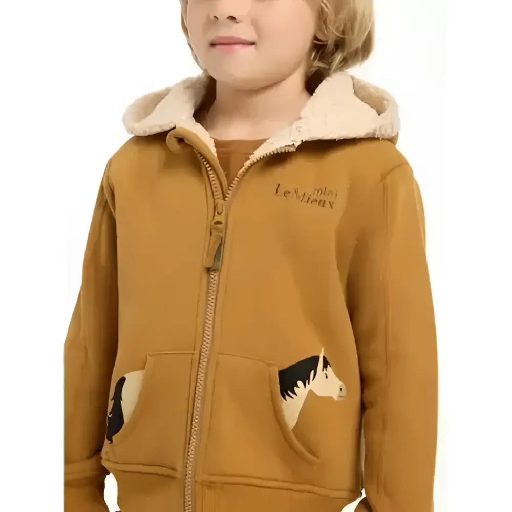 A mustard-yellow lemieux mini charlie hoodie ginger with super snuggly beige-lined hood and horse patch pockets