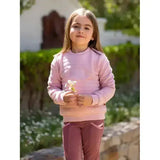 A soft pink lemieux mini cici long sleeve sweatshirt with quilted texture and ribbed cuffs in cici crew blossom style