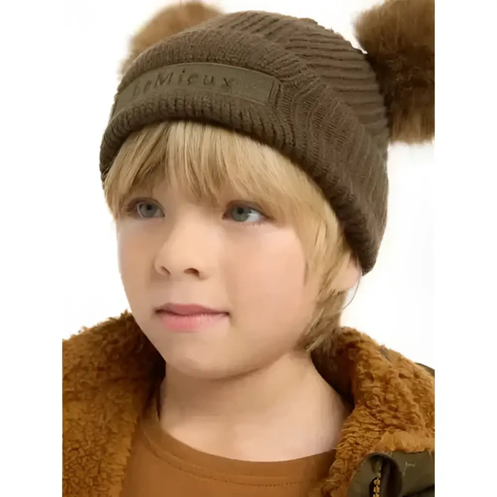 Brown knitted lemieux mini clara beanie with fluffy pom-poms perfect for alpine cold weather