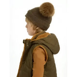 A cozy brown knitted lemieux mini clara beanie with a fluffy tan pom-pom perfect for alpine use