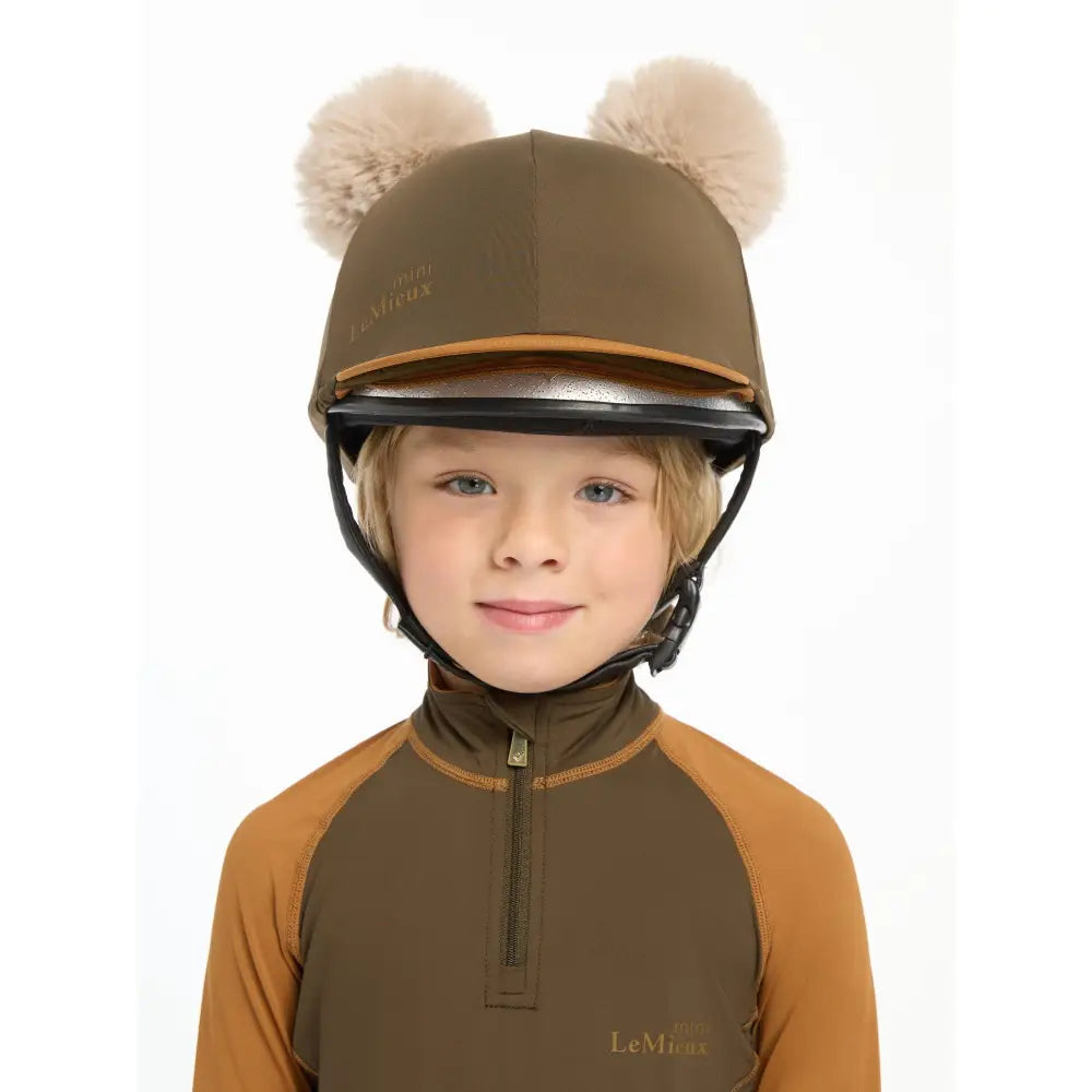 Equestrian helmet featuring Lemieux Mini Double Pom Hat Silk Alpine with fuzzy pom-pom ears