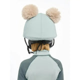 Light blue lemieux mini double pom hat silk glacier equestrian helmet with two fluffy beige pom-poms on top