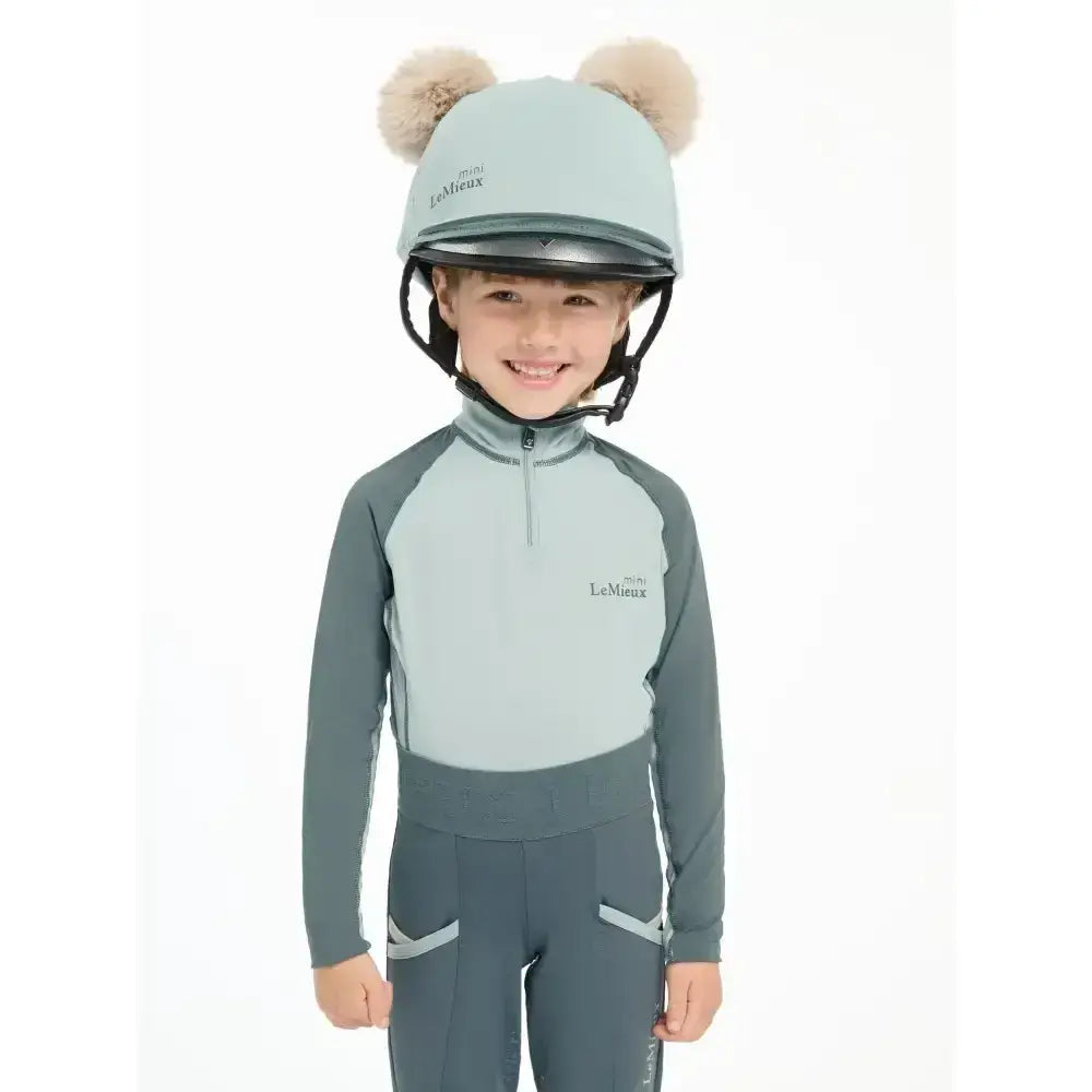 Light blue and gray lemieux mini double pom hat silk glacier with fluffy beige ear-like decorations for riding