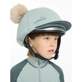Light blue lemieux mini double pom hat silk glacier padded equestrian helmet with fluffy beige pom-pom on top