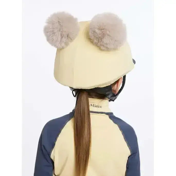 Cream-colored lemieux mini double pom hat silk mimosa equestrian helmet with two fluffy gray pom-poms on top