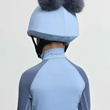 Light blue lemieux mini double pom equestrian helmet cover in silk powder blue with two gray fluffy pom-poms on top