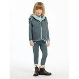 A child models a lemieux mini elsie reversible gilet petrol quilted dark teal vest with a blue hood and matching leggings