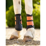 Black and orange lemieux mini grafter boots apricot with star emblem on strap for horse hooves