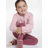 A young girl wearing a soft pink lemieux mini mari micro fleece blossom zip-up jacket with shimmering maroon leggings