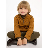 Young child in Lemieux Mini Mari Micro Fleece Ginger pullover, cross-legged