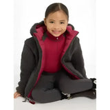 A child wearing a dark gray plush lined lemieux mini megan reversible puffer ember with vibrant magenta interior