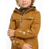 A child wearing a mustard-yellow lemieux mini milo winter jacket with white star sleeves and embroidered logo