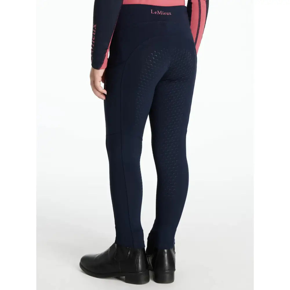 Back view of navy lemieux mini nora brushed pull equestrian leggings with pink accents and textured pattern