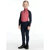 A child wearing a lemieux mini nora brushed pull on top in pink and navy blue with long sleeves and equestrian style