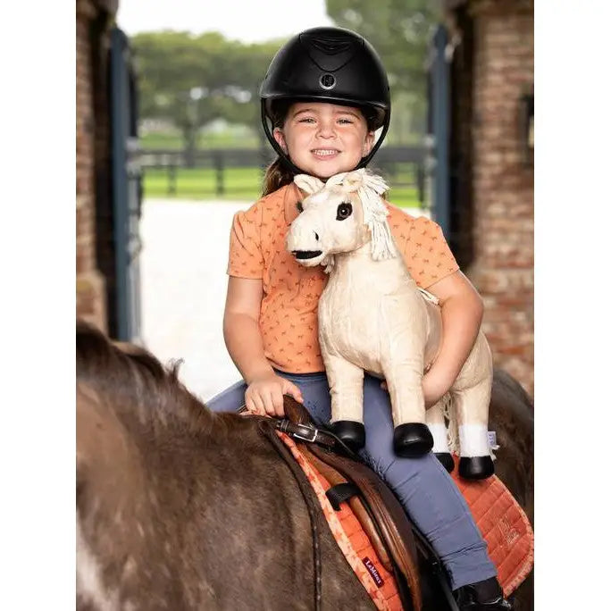 Child in Lemieux Mini Polo Shirt Sherbet on a horse with a stuffed animal