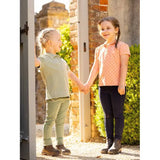 Two young girls in Lemieux Mini Polo Shirt Sherbet smiling outdoors, showcasing soft pique jersey