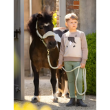 Child beside a small pony wearing a Lemieux Mini Pony Sweatshirt in Stone color