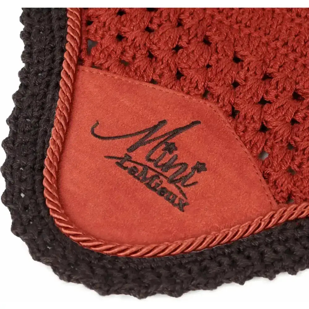 A rust-colored crocheted lemieux mini sienna saddle pad with black braided edge and mint la mieux suede patch from the premium designer collection