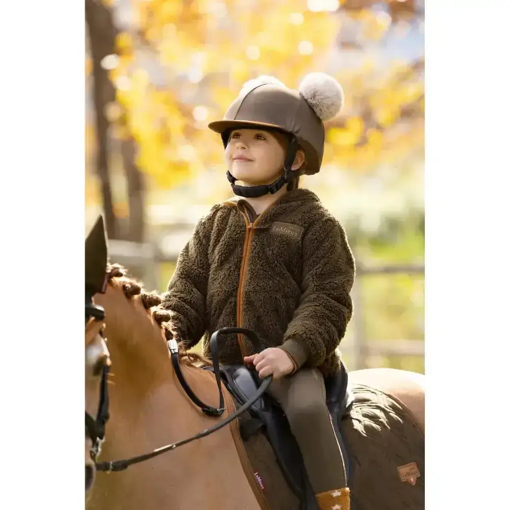 Brown fuzzy lemieux mini teagan fleece alpine jacket with tan zipper and brand patch on the chest