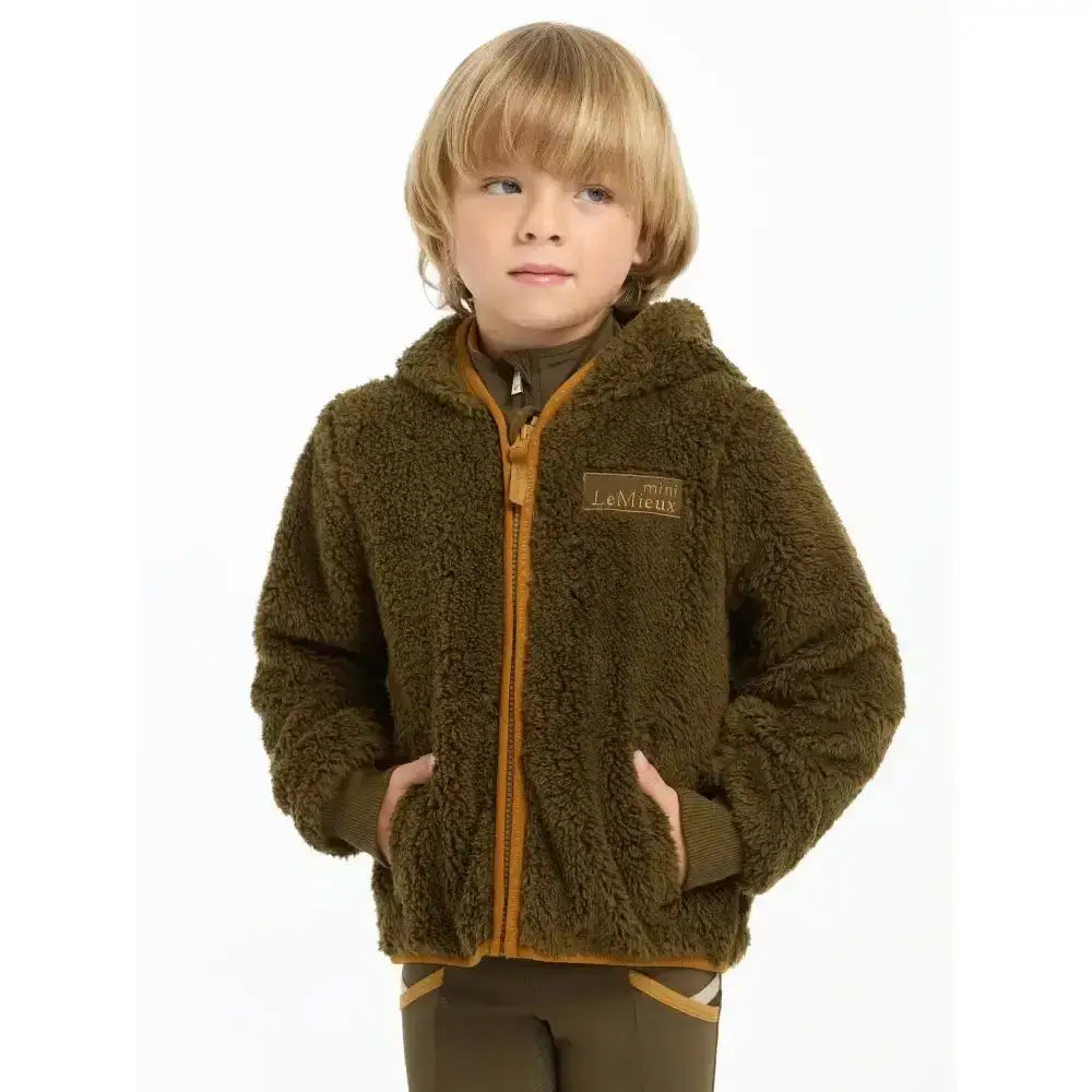 Olive green fuzzy lemieux mini teagan fleece alpine jacket with orange zipper trim and chest brand patch
