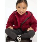 A child wearing a maroon lemieux mini teagan fleece ember jacket with black zipper and trim in plush material