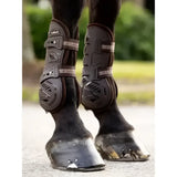 Black lemieux motion cool tendon boot with soft airprene perforated padding and adjustable straps for horse legs