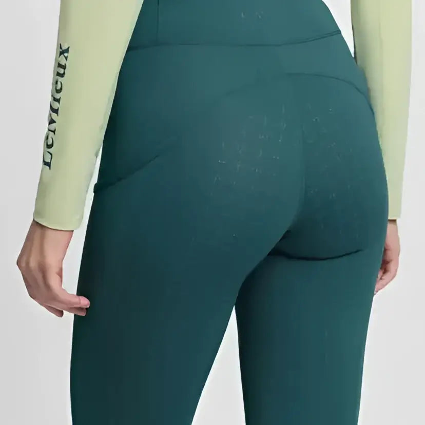 Teal high waisted lemieux naomi pull equestrian leggings with subtle texture and logo on sleeve jungle color