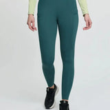 Teal high-waisted lemieux naomi pull leggings with sleek fit and subtle side pockets perfect for active wear