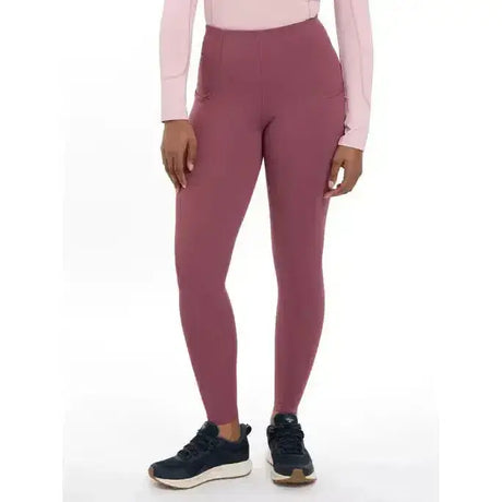 A pair of lemieux naomi pull high-waisted mauve leggings with stretchy fabric and subtle side pockets
