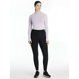 A woman wearing lemieux natalie’s brush black pull on leggings paired with a lavender long sleeve top and black shoes