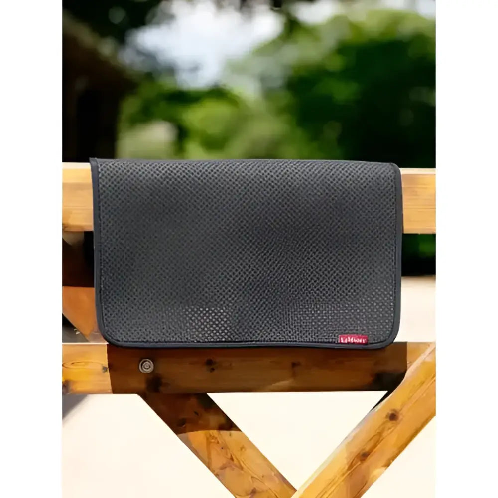 Black textured half pad square half pad with subtle perforated pattern and small red LeMieux logo on lower right corner