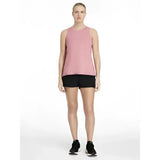 A soft pink sleeveless athletic top with subtle logo paired with lemieux penny shorts black for shorts layer look