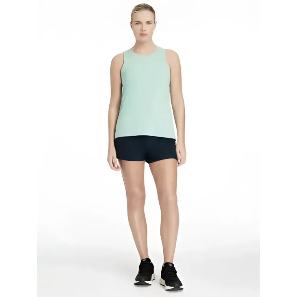 A light mint green sleeveless athletic tank top with rounded neckline paired with lemieux penny shorts navy shorts layer