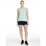 A light mint green sleeveless athletic tank top with rounded neckline paired with lemieux penny shorts navy shorts layer