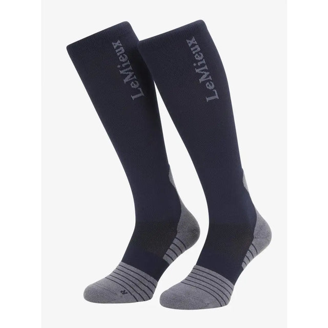 Navy blue and gray lemieux performance sock with padded heel and lemieux branding on the side in knee-high style