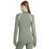 A sage green lemieux philippa mesh base layer rosemary with beige panels and high collar shown from the back side