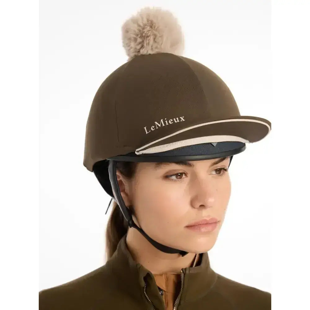 Brown lemieux pippa hat silk alpine equestrian helmet with fluffy beige pom-pom and white trim in silky smooth four-way stretch