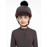 Dark gray lemieux pippa hat with black pom-pom and red trim made of silky smooth four-way stretch hat silk cinder