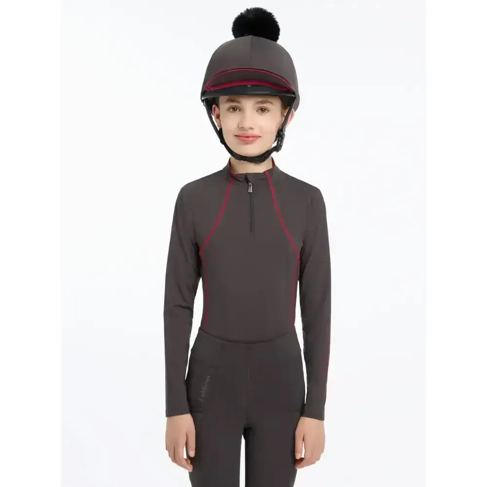 Dark gray lemieux pippa hat with a black faux fur pom-pom maroon trim made of silky smooth four-way stretch hat silk cinder