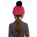Red lemieux pippa hat silk ember helmet with a black fluffy pom pom perfect for equestrian use