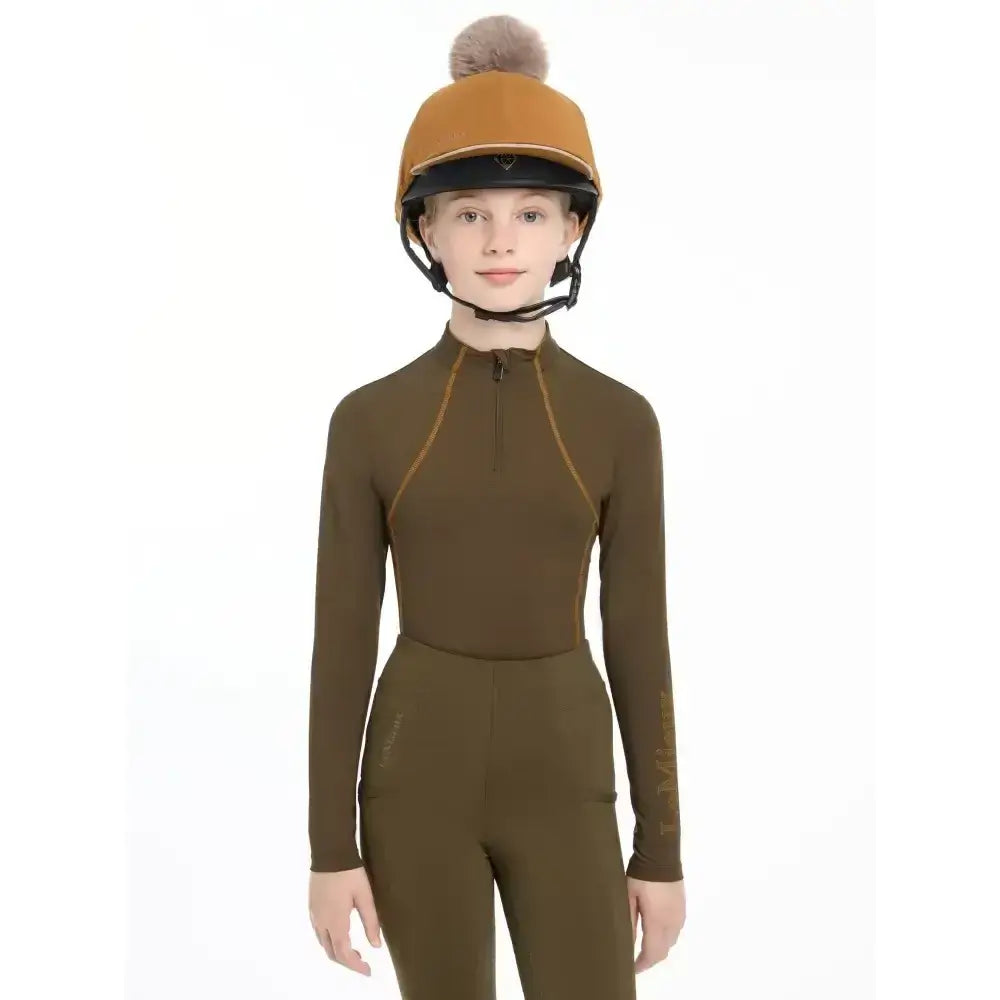 Olive green long-sleeved lemieux pippa hat silk ginger riding suit with tan zipper accents and matching pants