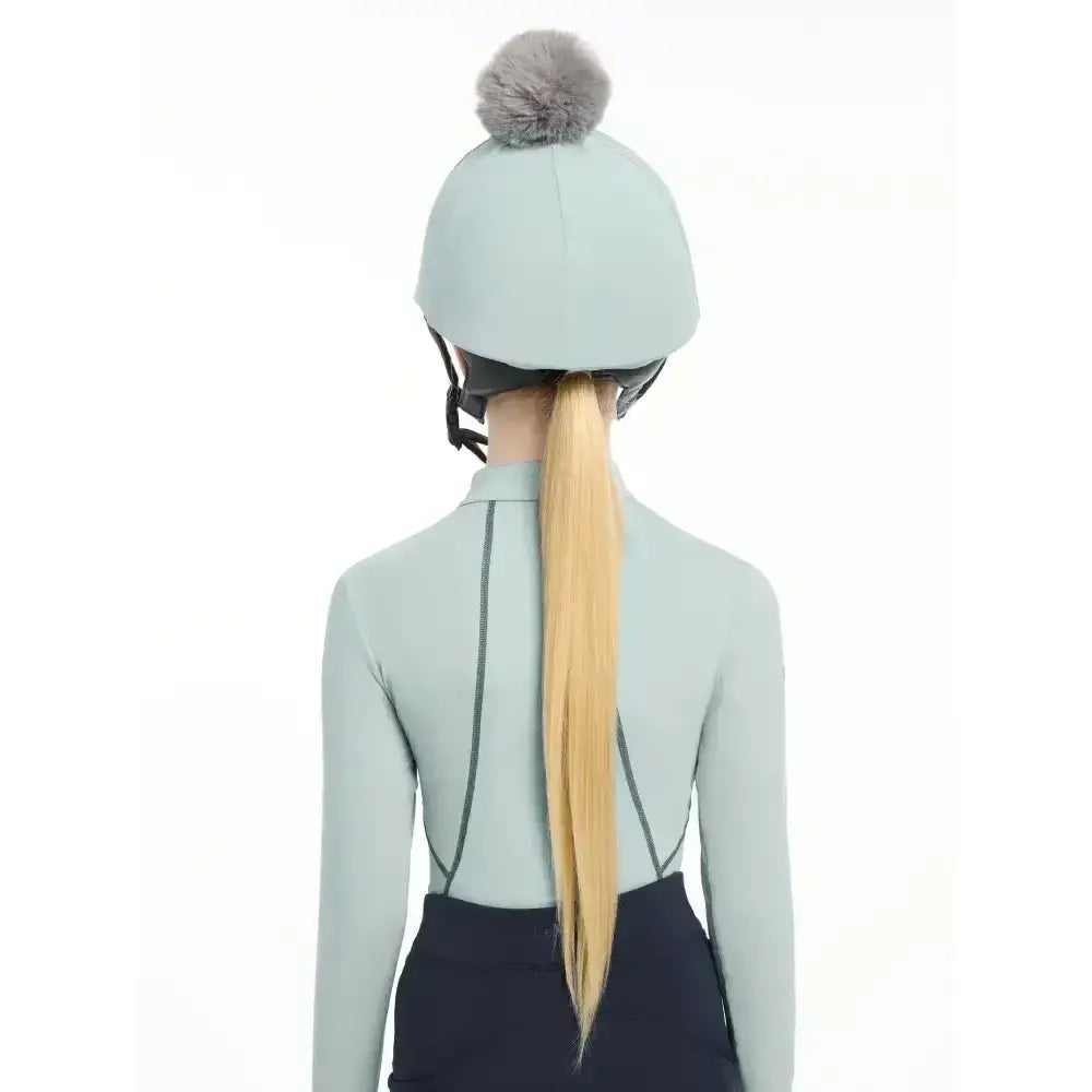 Light blue lemieux pippa hat silk glacier with gray faux fur pom-pom made from silky smooth four-way fabric