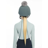 Gray lemieux pippa hat silk petrol with a fluffy gray pom pom made from silky smooth four way fabric for riding