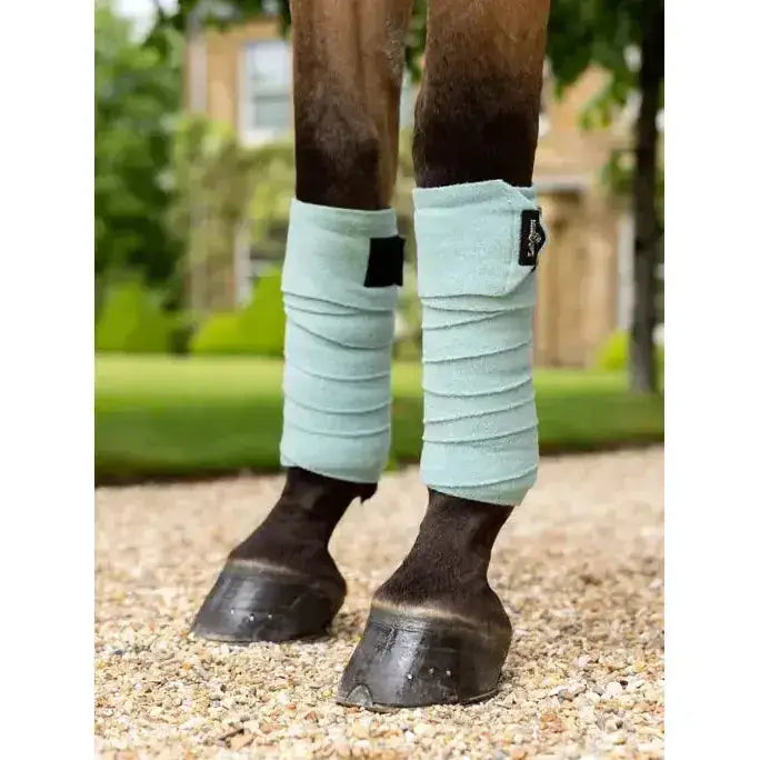 Light blue soft textured lemieux polo bandages aqua with black velcro wraparound closures for leg support