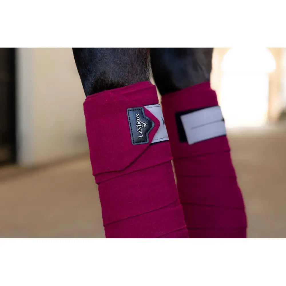 Bright pink Lemieux Polo Bandages Ember with attached brand labels for horse leg support