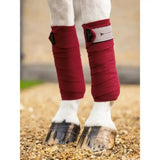Deep red soft textured lemieux polo bandages ember with sleek black and silver buckle detail for horse legs