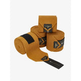Tan suede lemieux polo bandages ginger with black accents and lemieux branding for horse leg support